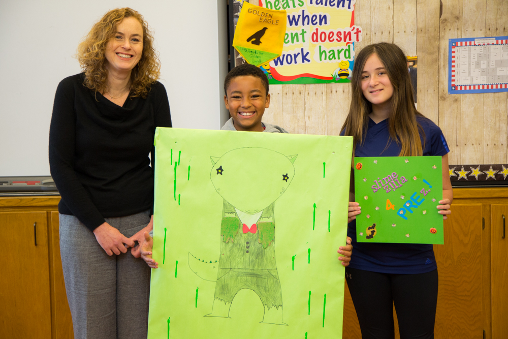 Laura and students with posters