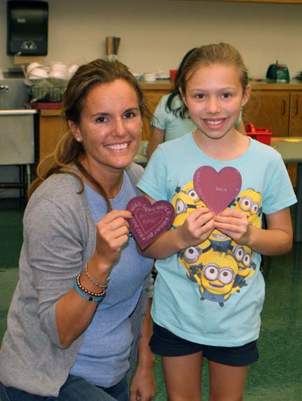 teacher and student with heart crafts