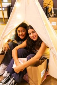 Middle School students with books, smiling