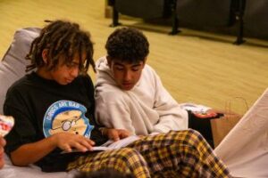 Middle school students reading together