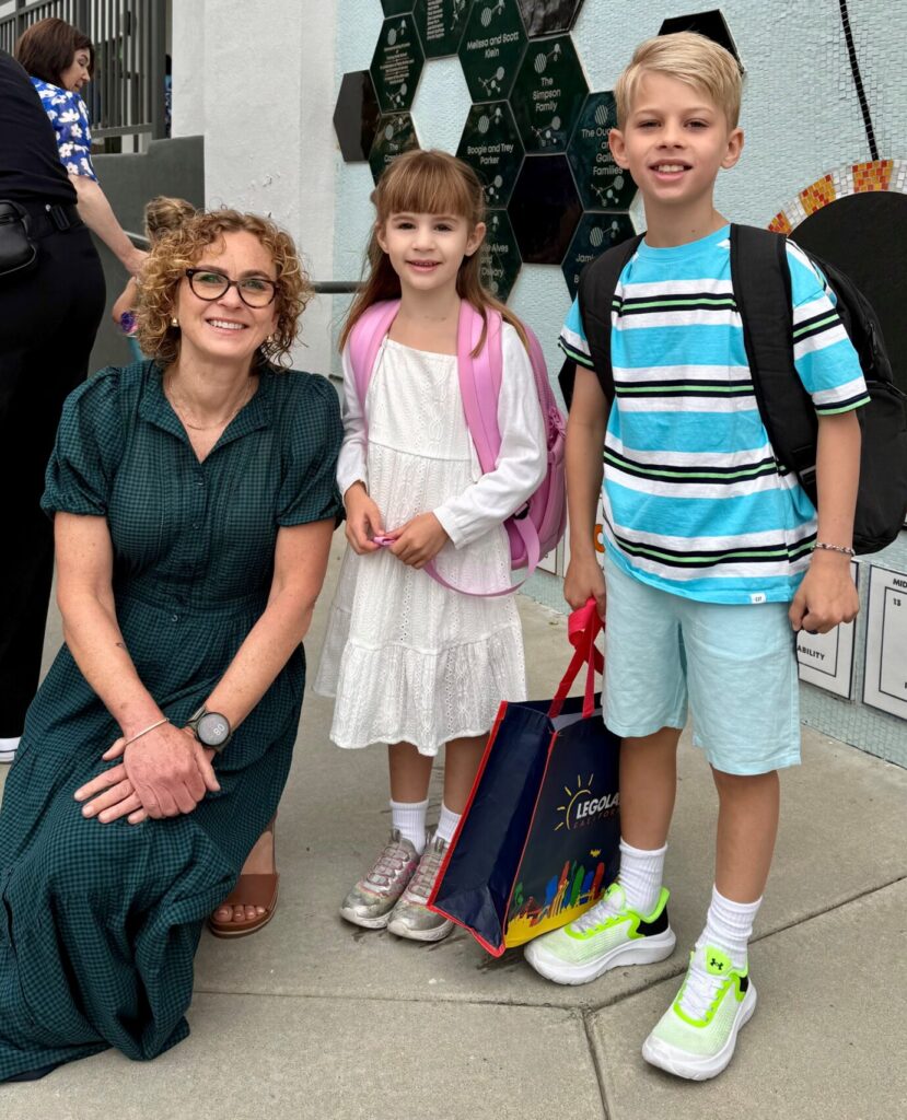 Head of School Dr. Konigsberg poses with two Turning Point School students on the first day of school.